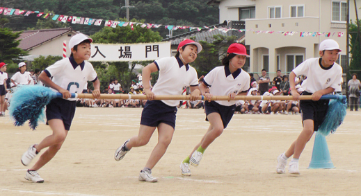 ６月開催となった運動会で元気に競技する児童たち＝尾崎小