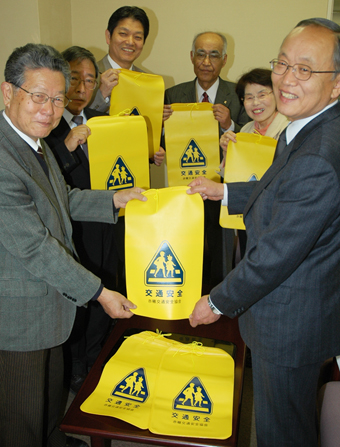 室井久和教育長(右)にランドセルカバーを贈呈する金川紀夫副会長