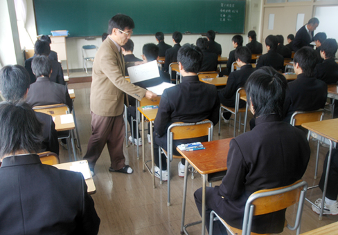 厳正な雰囲気の中、問題用紙が配られる高校入試