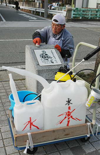 四十七士石碑を清掃奉仕する米野さん＝２００７年２月４日撮影